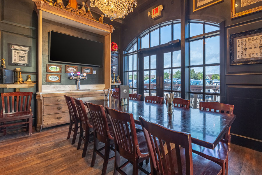 Private dining room with television, large windows, and doors.